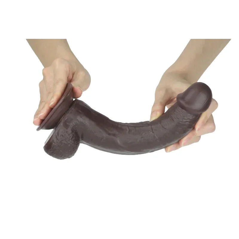 Person holding a brown dildo on a white background