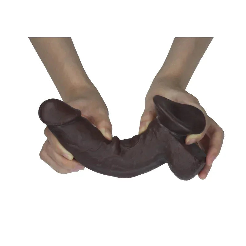 Brown dildo held by hands on a white background