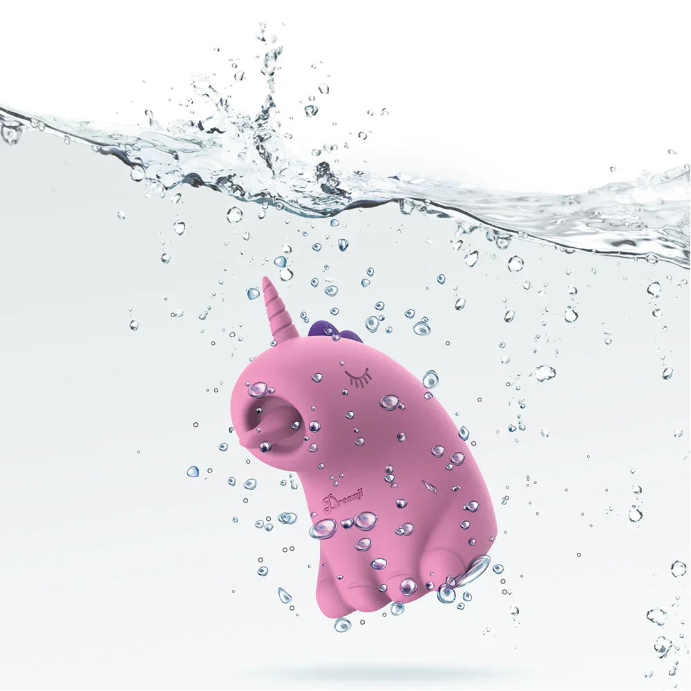 Pink unicorn toy with a horn and a tail, floating in water with bubbles.