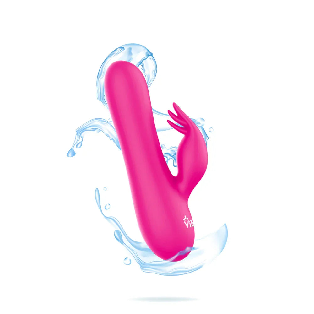 Pink silicone toy with water droplets on a white background