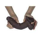 Brown dildo held by hands on a white background