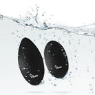 Black Viben toy with water droplets and splashes on a white background