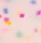 Colorful confetti on a light pink background
